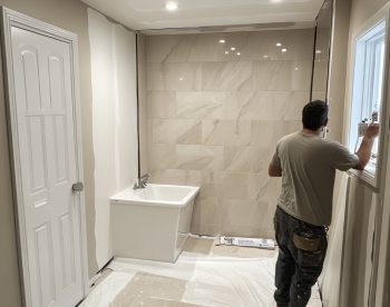 painting a bathroom wall during a bathroom remodel