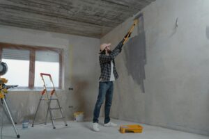 Man painting his wall